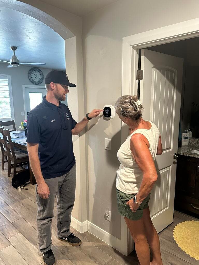 Marlin Plumbing Heating & Air installing a new high-efficiency central air conditioning system at a St. George, Utah home