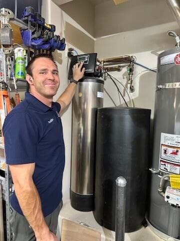 Marlin Plumbing technician installing a whole-home water softener system in St. George, Utah
